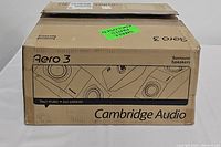 Closed box of Cambridge Audio Aero 3 surround speakers with branding and model details visible.