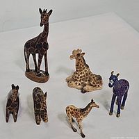 Overview of all six giraffe figurines showing different styles and sizes