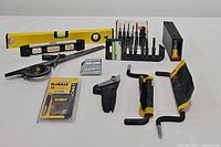 Overview of all tools including spirit levels, clamps, screwdriver set, tape measure, and drill bits.