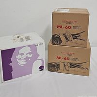 Set of three boxed speakers: MartinLogan ML-60, ML-65 Installer Series and Athena AS-IW6, arranged against white backdrop.