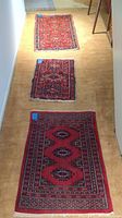 Photo showing all three runners laid lengthwise on carpeted floor for size comparison and design detail overview.