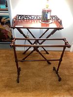 Photo showing the folding wooden table tray on top and wooden blanket rack below, both with turned wood elements and dark brown finish.