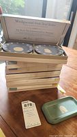 Stack of six Wedgwood State Seal Series plates in original boxes, set numbers 8 to 13, with additional small rectangular dish in front