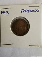 Obverse side of the 1943 farthing coin showing the portrait of King George VI with inscription.