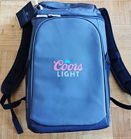 Front view of Coors Light cooler bag showing logo and main compartment.