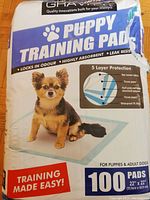 Front of package showing branding, product name, usage for puppies and adult dogs, and quantity of 100 pads.