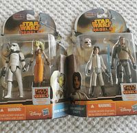 Two unopened Star Wars Rebels action figure packs, one containing Hera Syndulla and a Stormtrooper, the other containing Ezra Bridger (Cadet) and a Sandtrooper. Original packaging sealed but shows some edge wear.