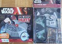 Photo showing two Star Wars Galaxy Hunt Game boxes, front views with packaging, game components visible through plastic, unopened.