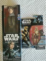 Front photo showing Sergeant Jyn Erso figure in its packaging alongside Shoretrooper figure in blister pack with Star Wars Rogue One branding and age recommendation 6+.