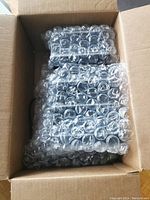 Box containing bubble-wrapped tablets and charger