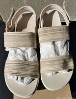 Pair of new women's Clarks sandals with white sole, double striped fabric straps, and Velcro back strap taken from above