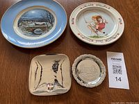 Overview of five decorative plates and trays on wooden surface.