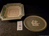 Photo showing Fitz and Floyd square bowl and Wedgewood jasperware plate together on black background.