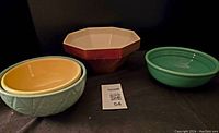 Photo of three bowls: yellow, octagonal beige-brown Haeger, and green round bowl.