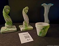 Pair of Westmoreland slag glass spiral candlesticks and Akro agate mini pot on a dark surface against a black background with lot card