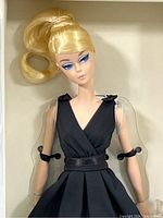 Close-up of doll head and bodice showing makeup and dress detail