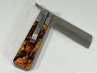 Full view of the Gerber Jukebox pocket tool opened showing the straight edge blade and patterned handle.