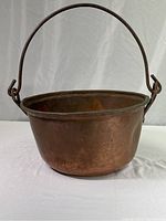 Image showing the large copper pot with handle upright, against a white background.