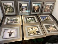 Full view of all ten framed photographs arranged together on a surface