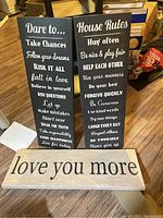 Three canvases displayed together on floor showing their size and text content