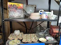 Shelf with Regency crystal punch bowl set including glasses, white ceramic pieces, and assorted decorative China plates.