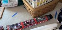 Rolled sports team poster on tabletop, includes some basketball and football imagery visible