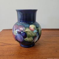 Front and full-body view of the vase showing floral motif and glaze