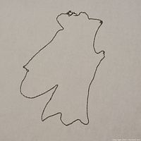 Full view of thin linked 14kt gold chain on cream background.