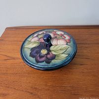 Top-angled view of covered bowl showing floral design on lid