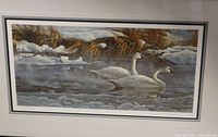 Front view of the framed lithograph showing two swans in icy water and snow-covered bank
