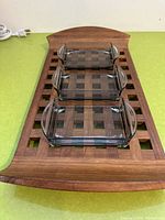 Top view showing three smoked glass dishes on the teak trellis tray with handles.