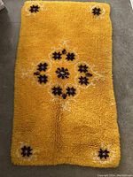 Front side of the vintage hand knotted rug showing deep yellow color and center medallion with matching corners.