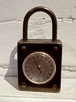 Front view of the brass padlock shaped thermometer showing overall shape and size.