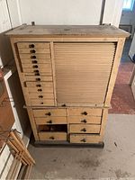 Front view showing left drawer bank and right tambour door