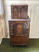 Full frontal view of two-piece oak cabinet showing overall proportions and style