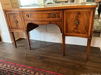 Full front view of sideboard showing central drawer and side cabinets