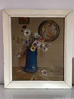 Full view of framed oil painting showing blue vase with flowers and background medallion.