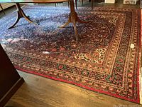 Full view of carpet under table showing overall pattern and border