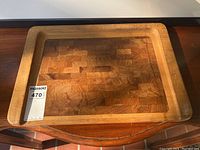 Top-down view of the rectangular teak serving tray on wooden surface