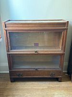 Front view of stacking bookcase showing two glass-front sections and bottom drawer