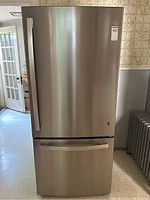 Front view of stainless steel French door refrigerator with bottom freezer drawer visible
