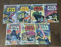 Seven Marvel Star Wars comic books laid out in one row showing front covers.