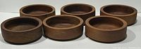 Six round teak wood salad bowls arranged in two rows, showing wood grain and finish.
