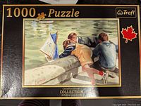 Trefl 1000-piece Canadian Artists Collection puzzle box featuring children leaning over a stone ledge, playing with toy sailboat on water.