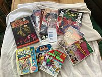 Overview photo showing 2 DVD cases, 3 Archie digest comics, Afterlife with Archie graphic novel, and multiple Jughead comic books.