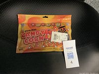 Front of the original packaging showing colorful candy corn themed graphics and size large label.