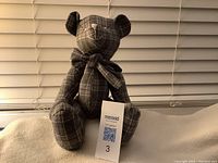 Front view of vintage jointed teddy bear made from dark plaid fabric, 43cm tall, with bow tie