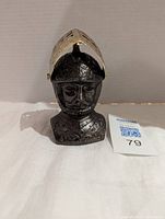 Front view of the vintage medieval knight lighter showing the detailed black bust with a silver metal helmet visor open revealing the knight's face.