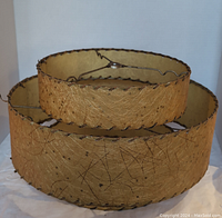 Front view of the large 3-tier yellow fiberglass lampshade showing texture, patterns and metal frame supports.