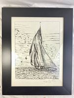 Framed signed black and white print of the Bluenose ship sailing with clouds and birds.